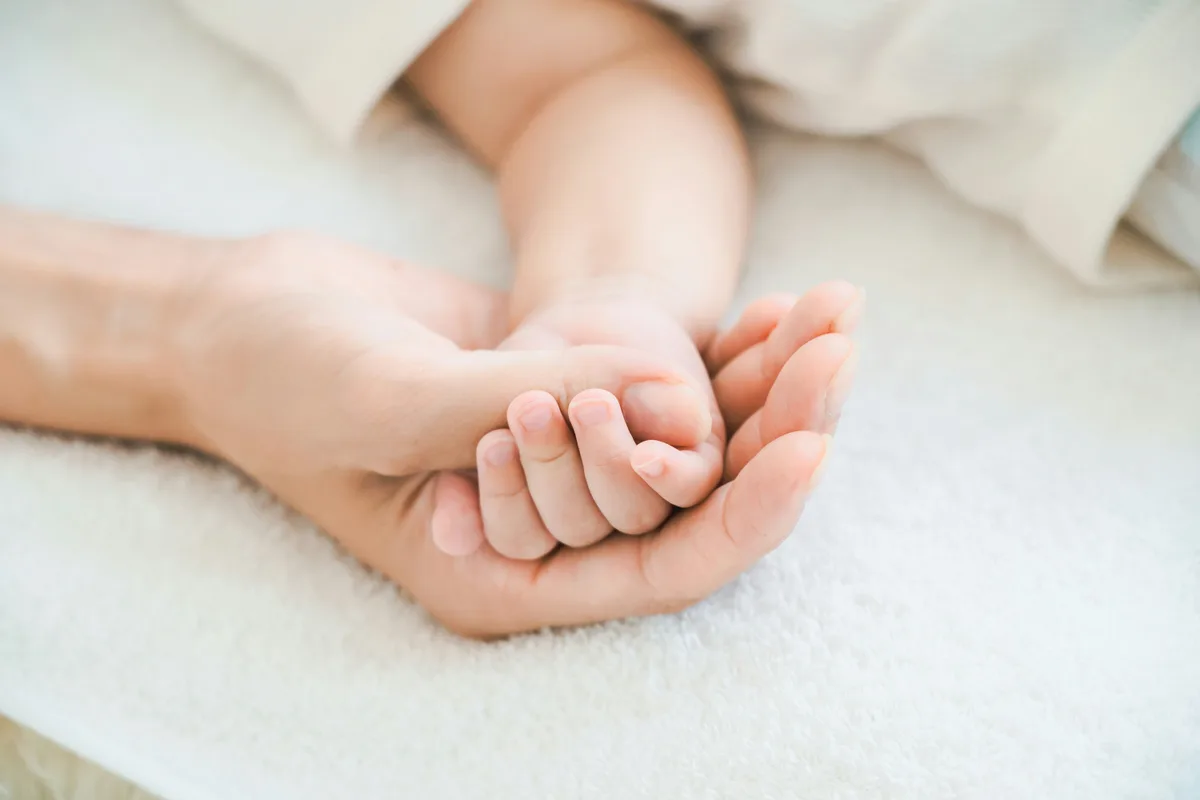 Mother holding and bonding with baby in postpartum recovery care
